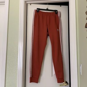 Rust orange adidas sweatpants. Medium